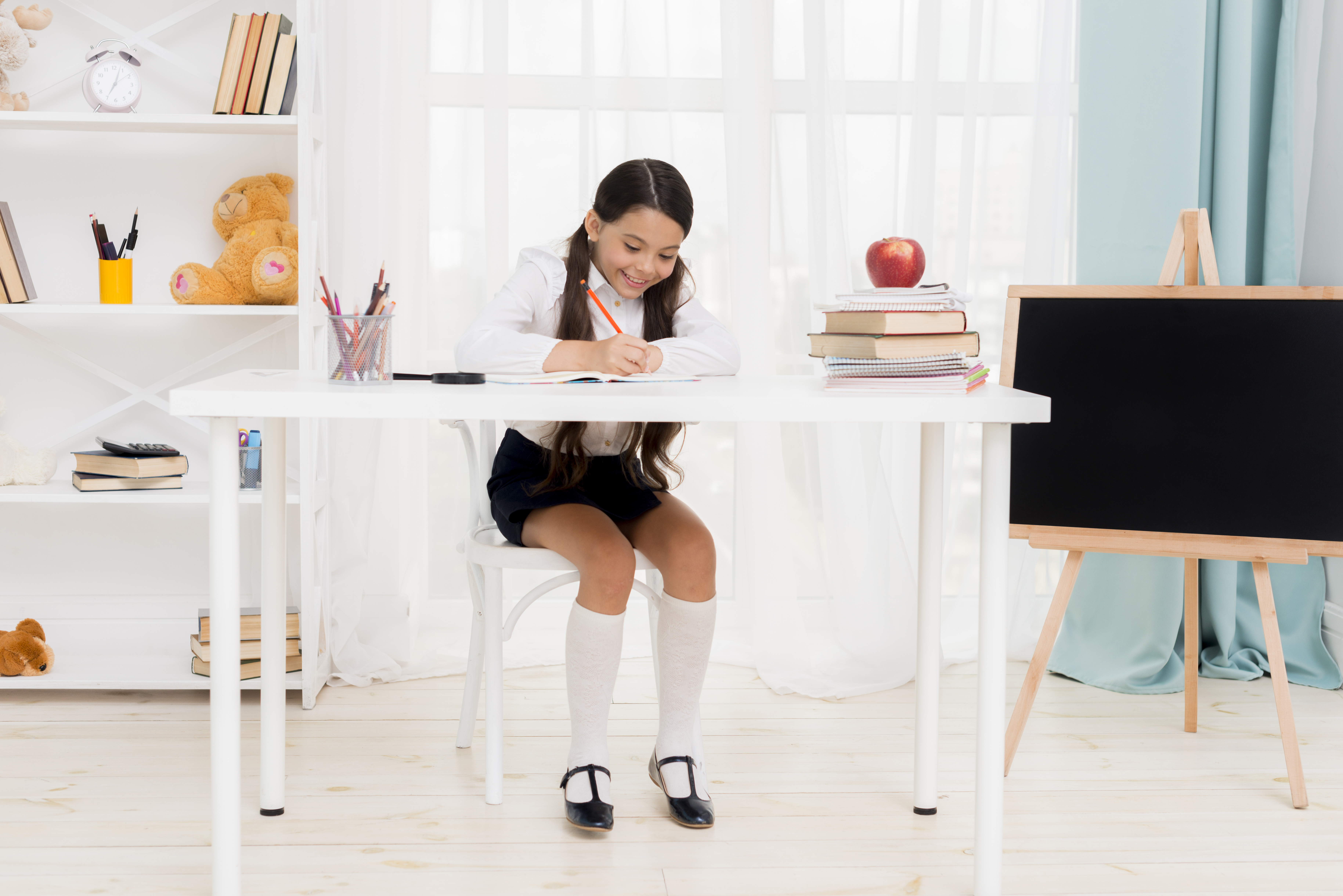 cute-schoolgirl-sitting-desk-exercising-classroom