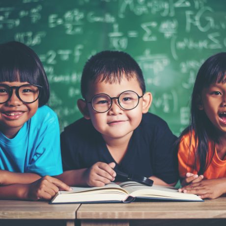 pupils  reading a book in the classroom.